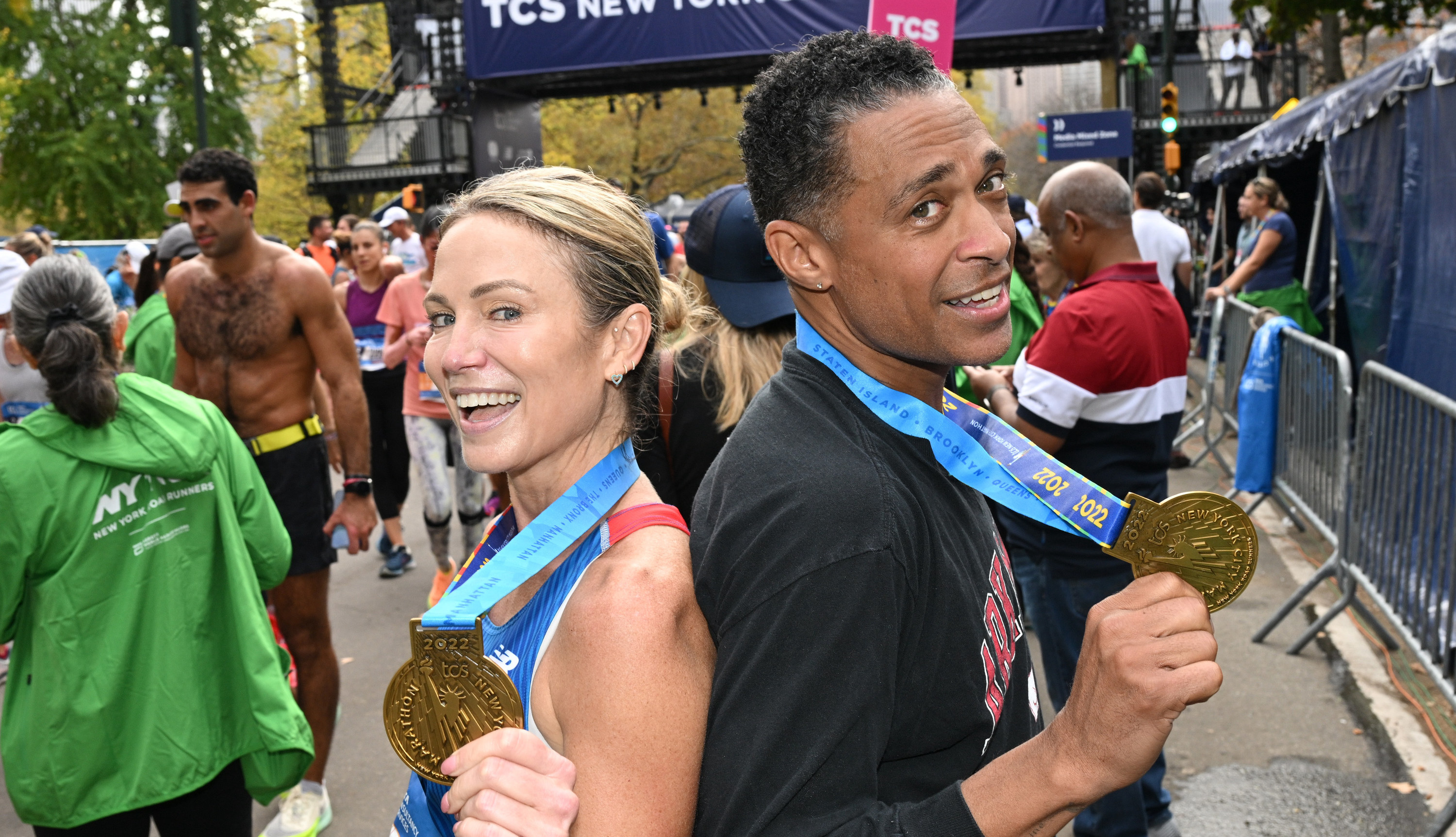 the two showing off their marathon medals