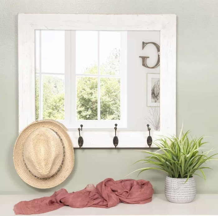 white mirror with hooks