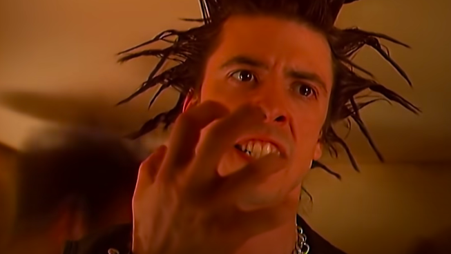 A man with spiky hair looks enraged