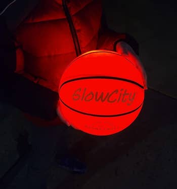reviewer's child holding the glowing basketball