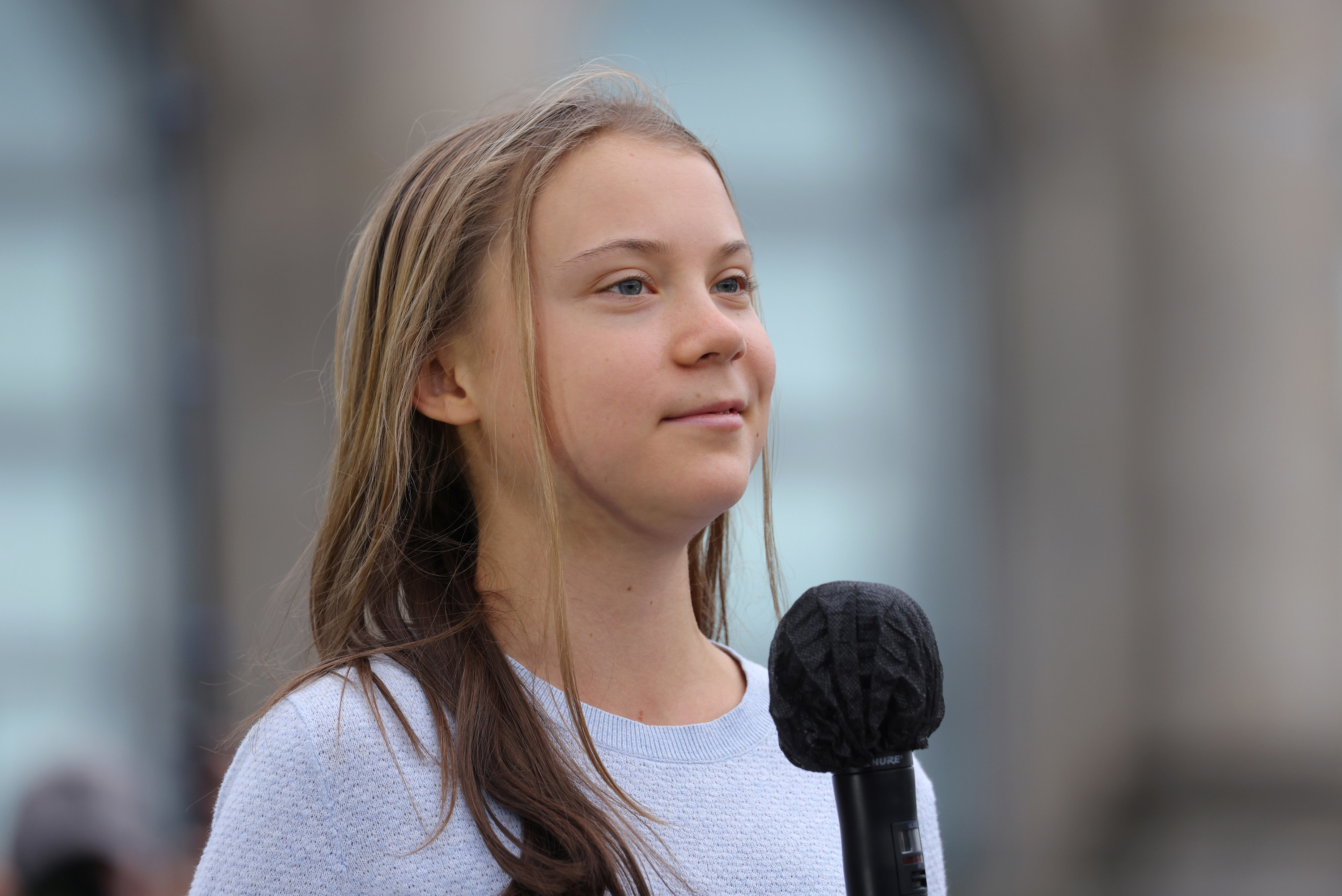 Greta at a microphone