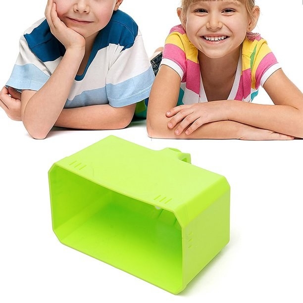 Two kids looking a green block maker