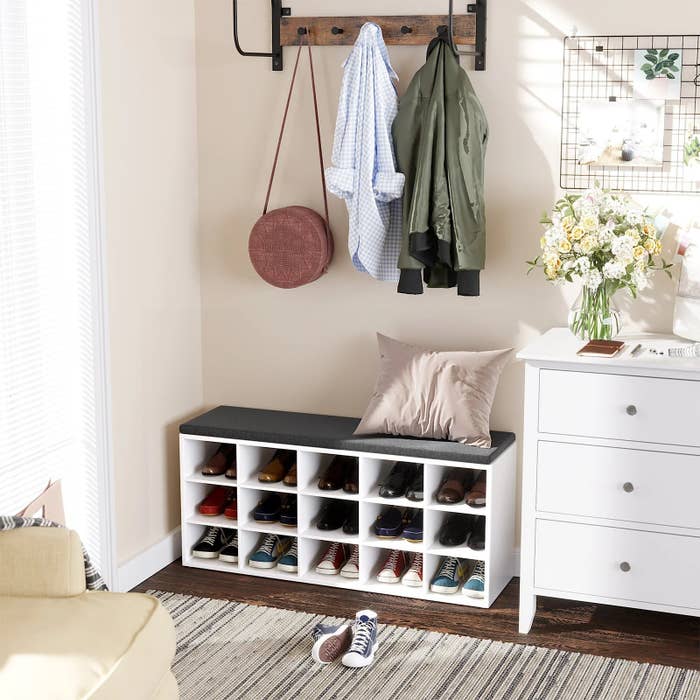 White shoe storage bench with shoes inside