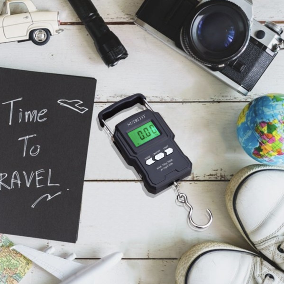 the luggage scale surrounded by travel items