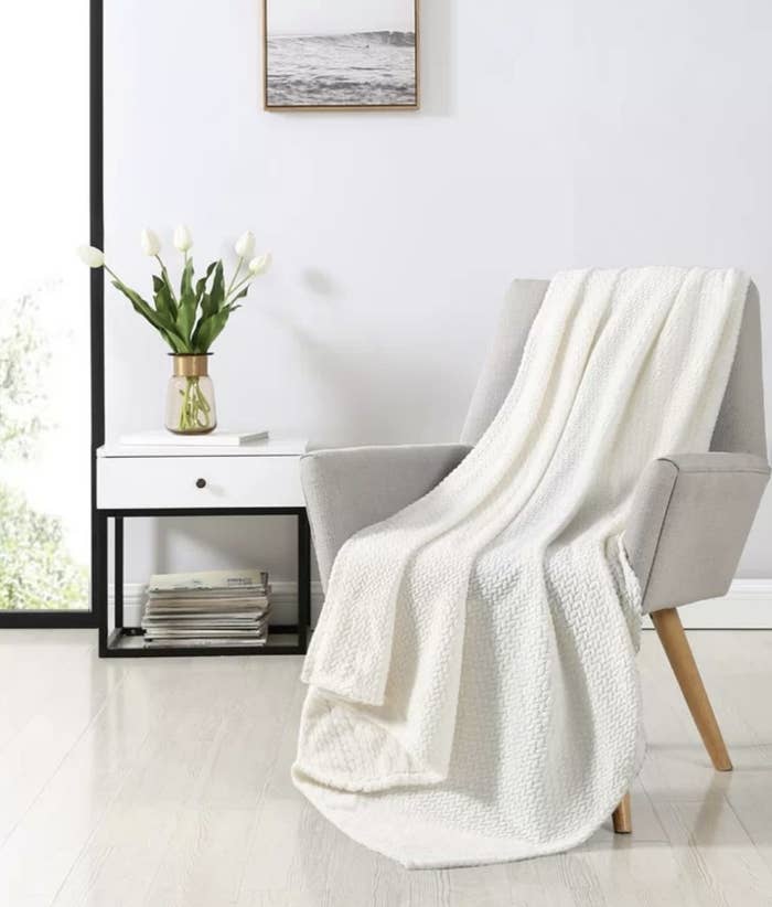 A white throw blanket on a chair