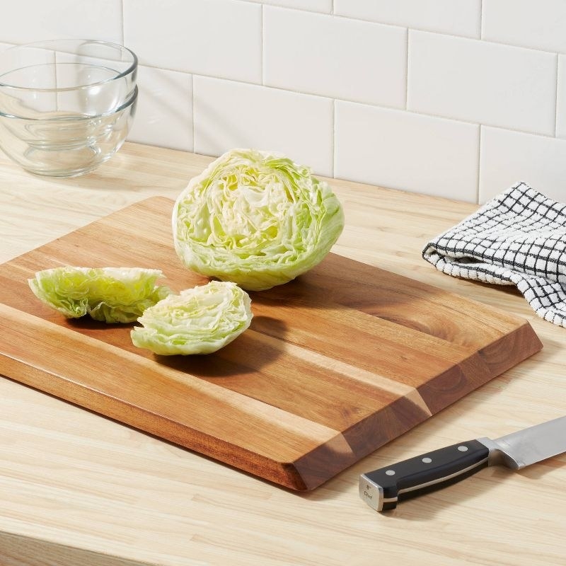 The cutting board with a sliced cabbage on it