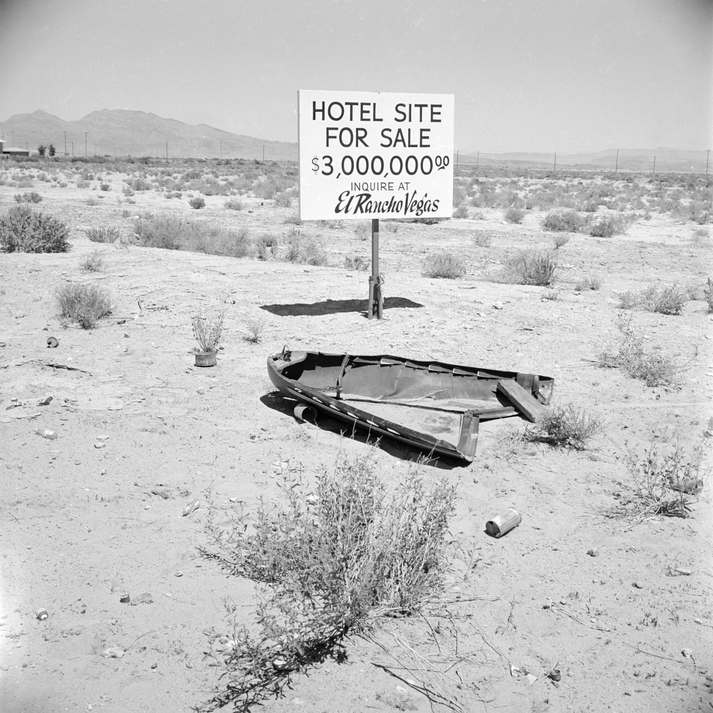 &quot;Hotel site for sale&quot; sign in the middle of an arid landscape