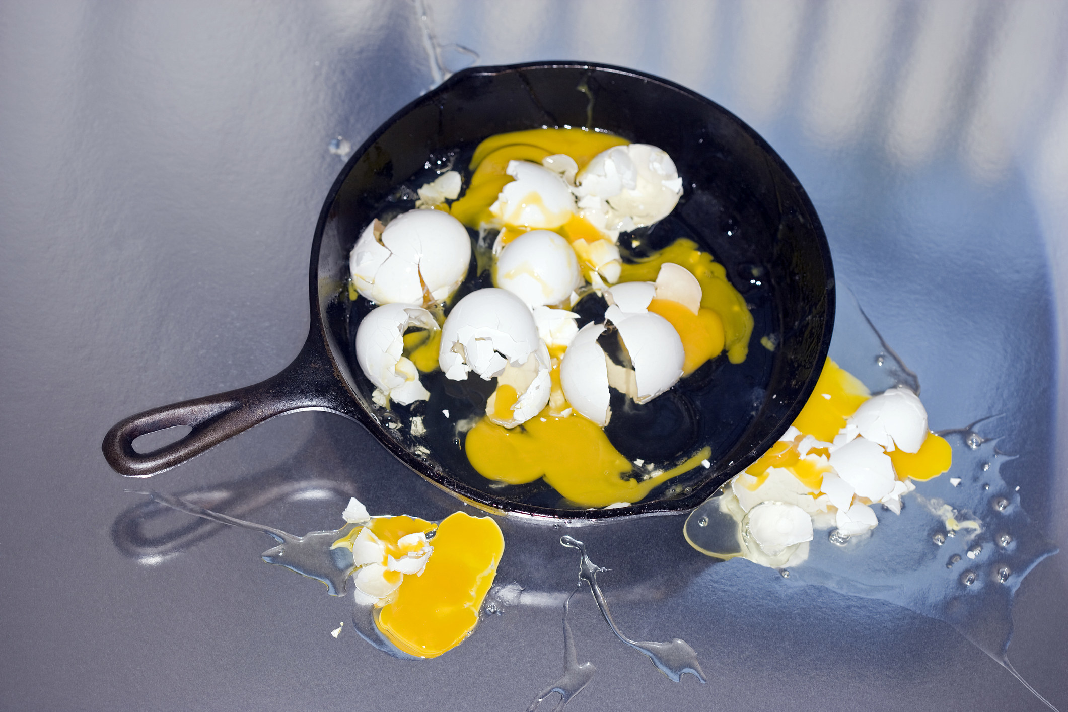 Eggs and eggshell in a frying pan