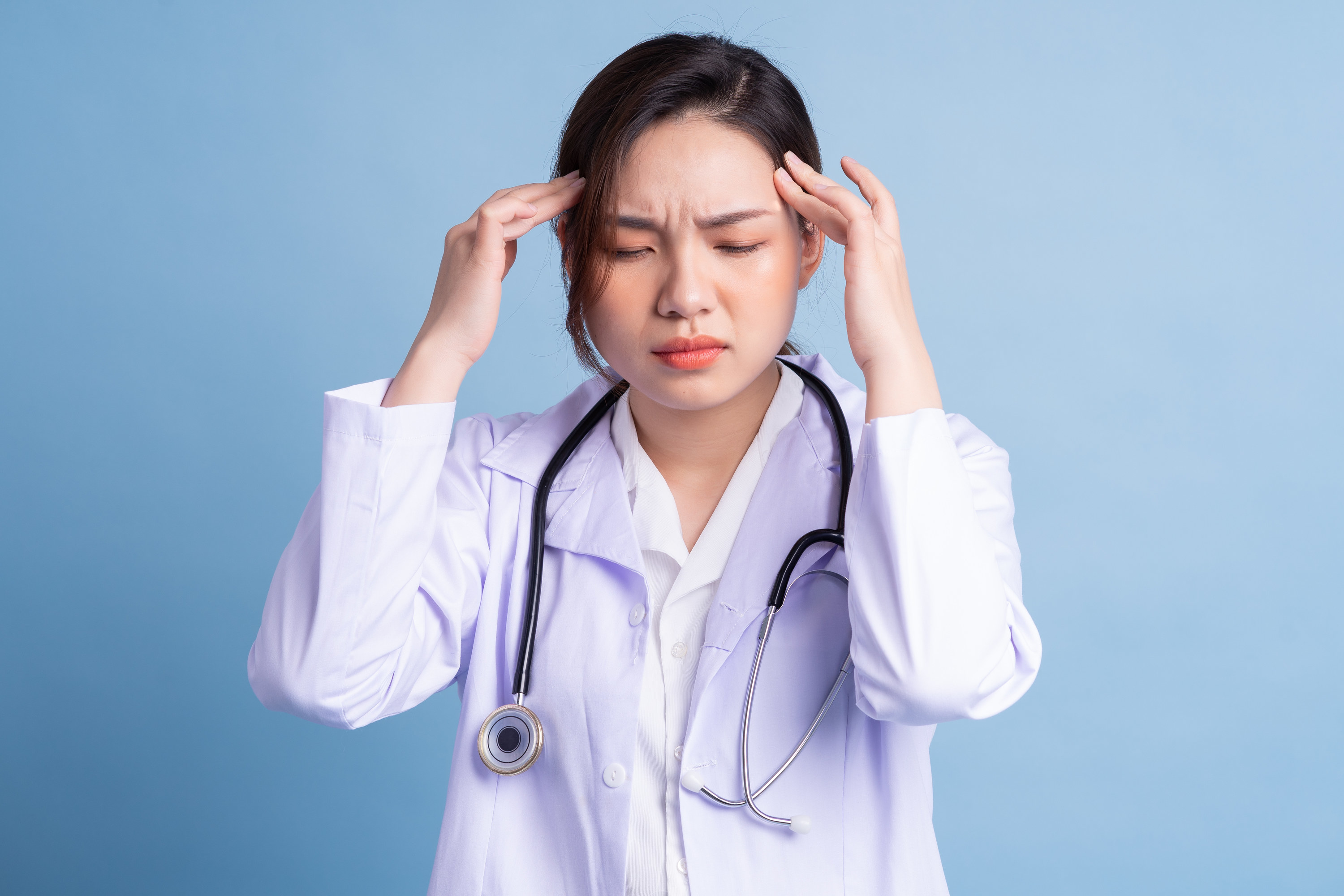 Frustrated doctor holding her head