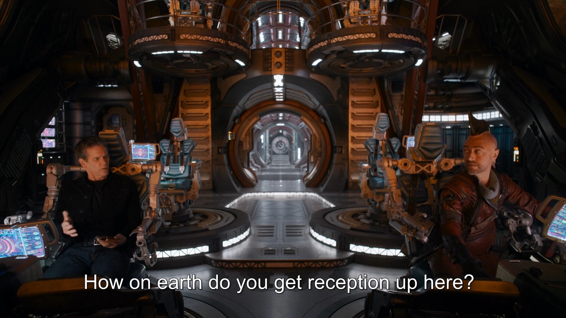 Kevin Bacon and Sean Gunn talk inside a spaceship
