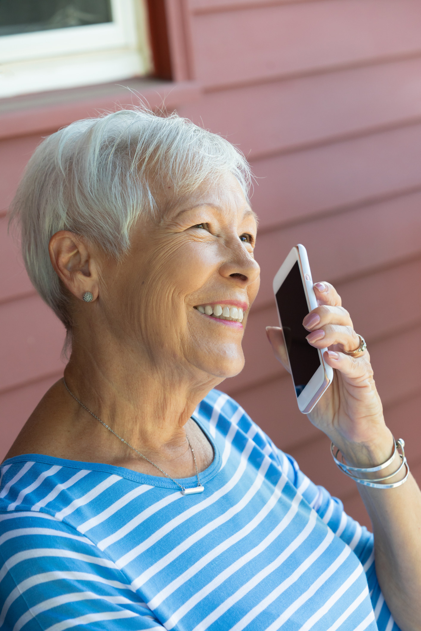 A woman smiling while talking on her phone