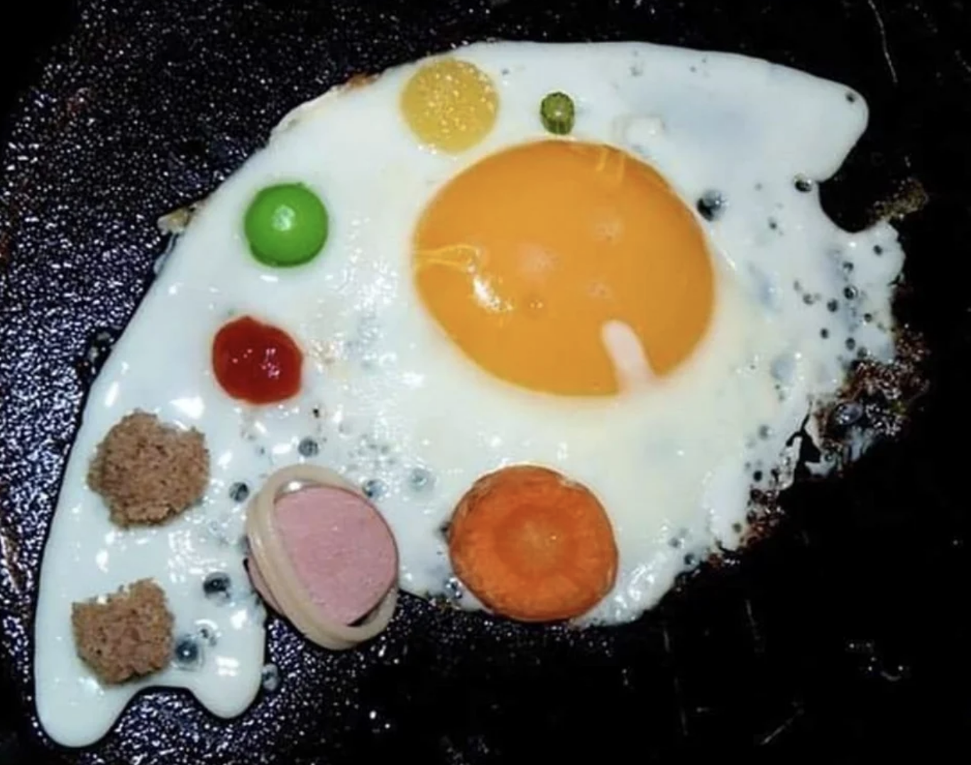 omelet with random pieces of food to make it look like the solar system