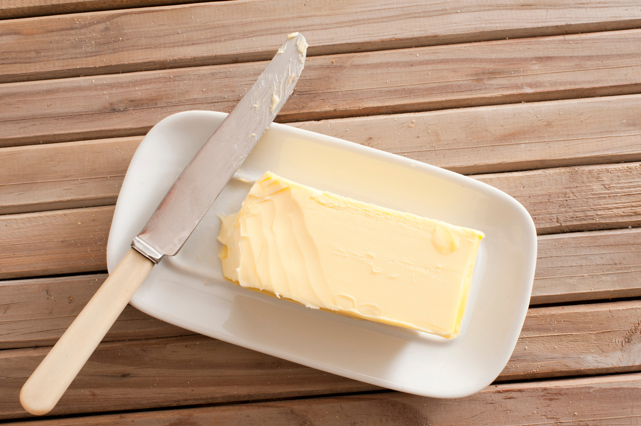 Butter sits on dish with knife
