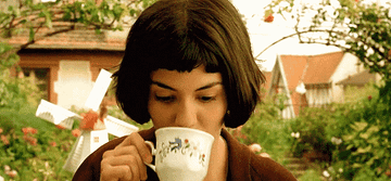 Amelie drinking from a teacup
