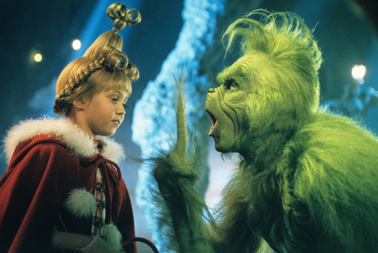 the grinch pointing a finger up to sally who