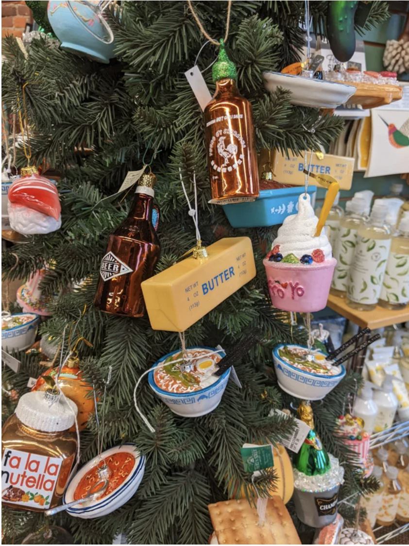 sticks of butter hanging on a Christmas tree among food ornaments