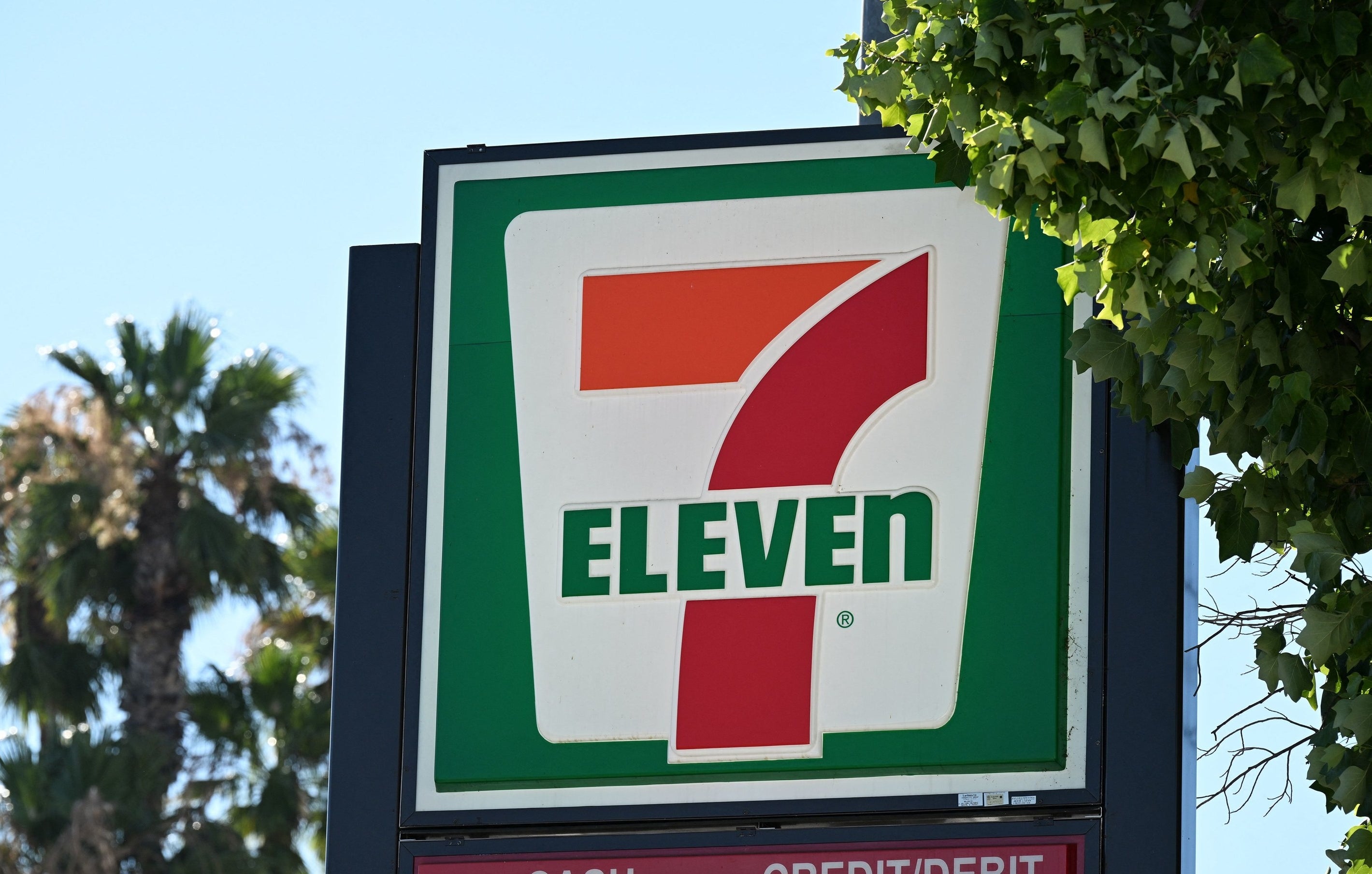 A sign outside a 7-Eleven store