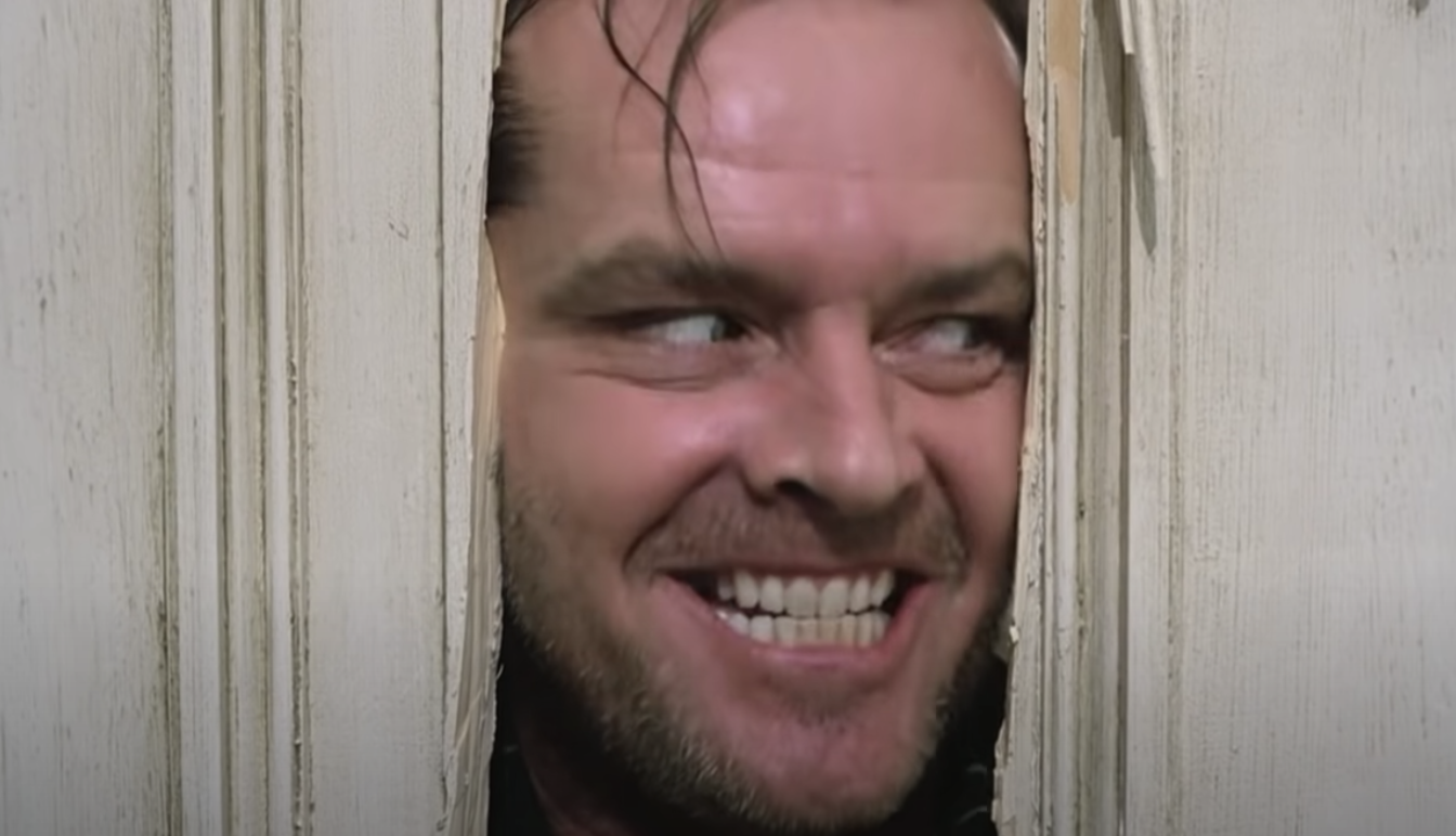 jack nicholson smiling menancingly in broken door frame