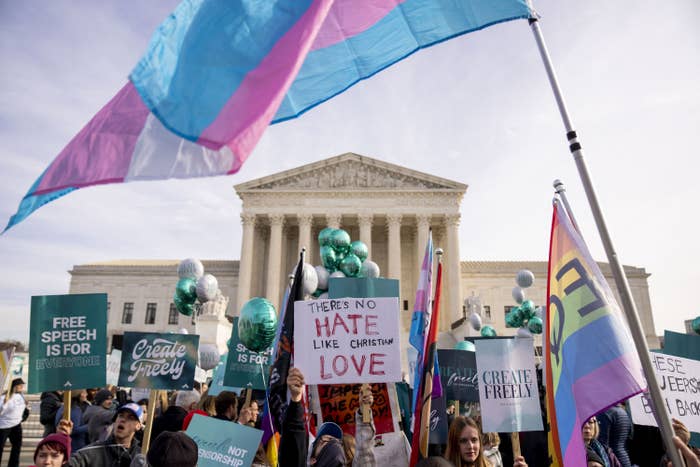 Protesters wave pride flags, trans pride flags, and signs that read &quot;there&#x27;s no hate like Christian love&quot; and &quot;free speech is for everyone&quot;