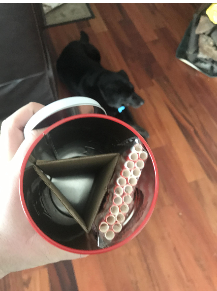 A Xmas tin with around 20 straws and just a piece of cardboard inside it