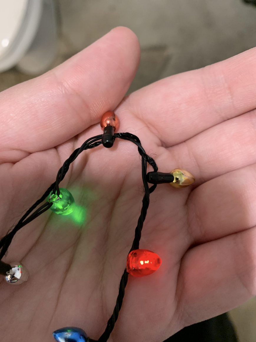 Very small Xmas lights in someone&#x27;s hand