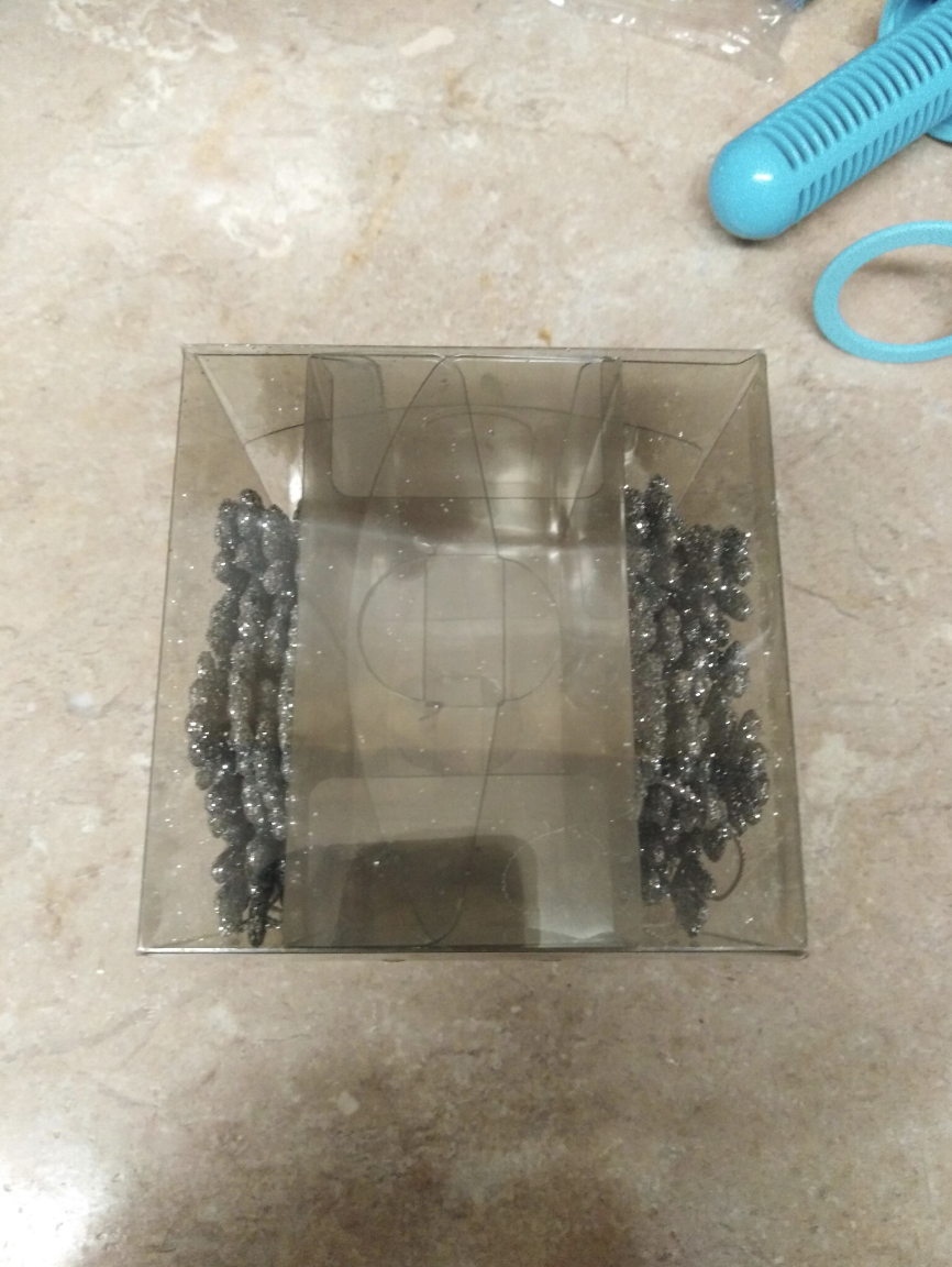 A transparent pack of &quot;ornaments on either side and a huge empty center