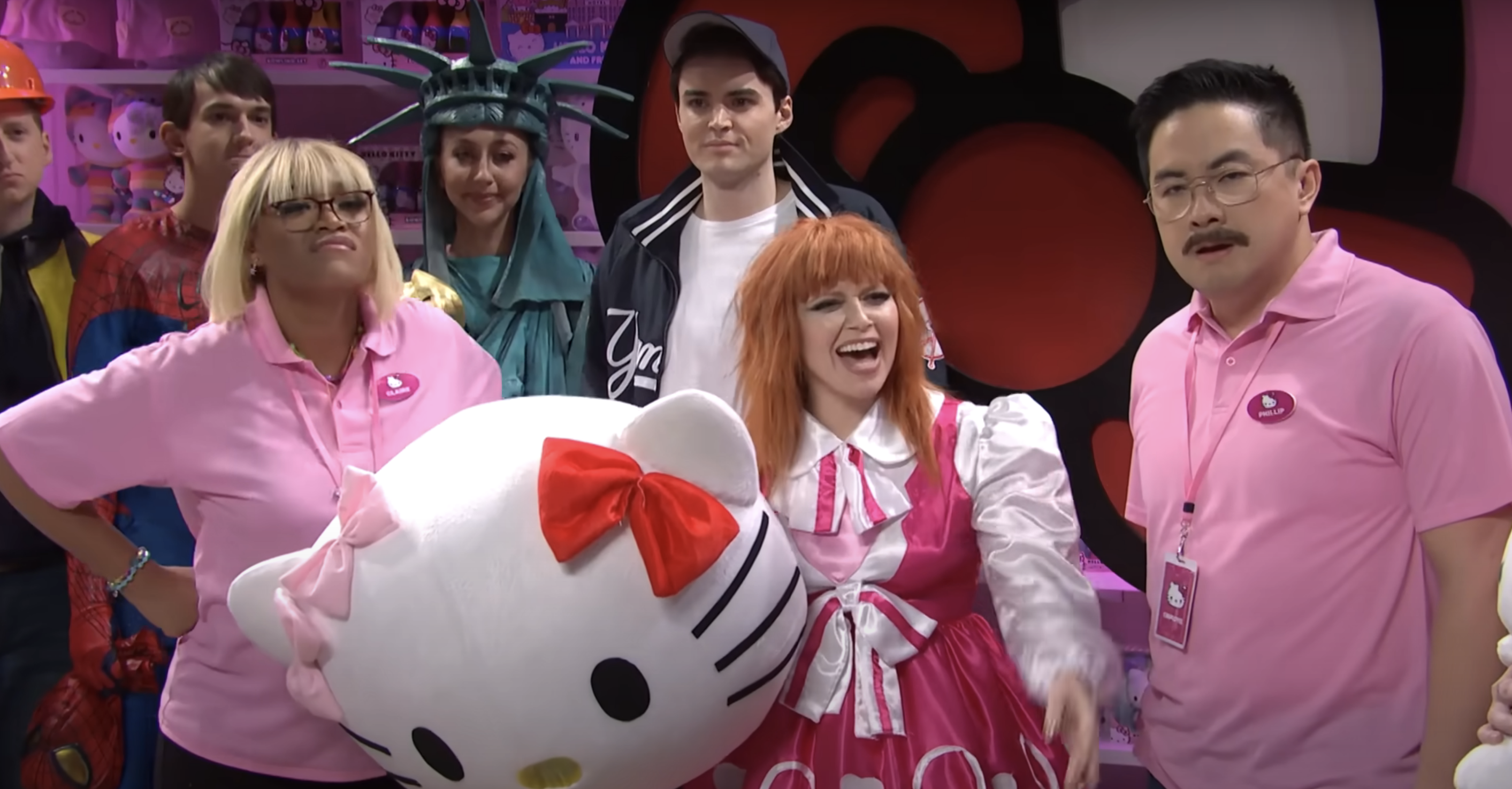 Natasha Lyonne holding a Hello Kitty head and dressed in the costume