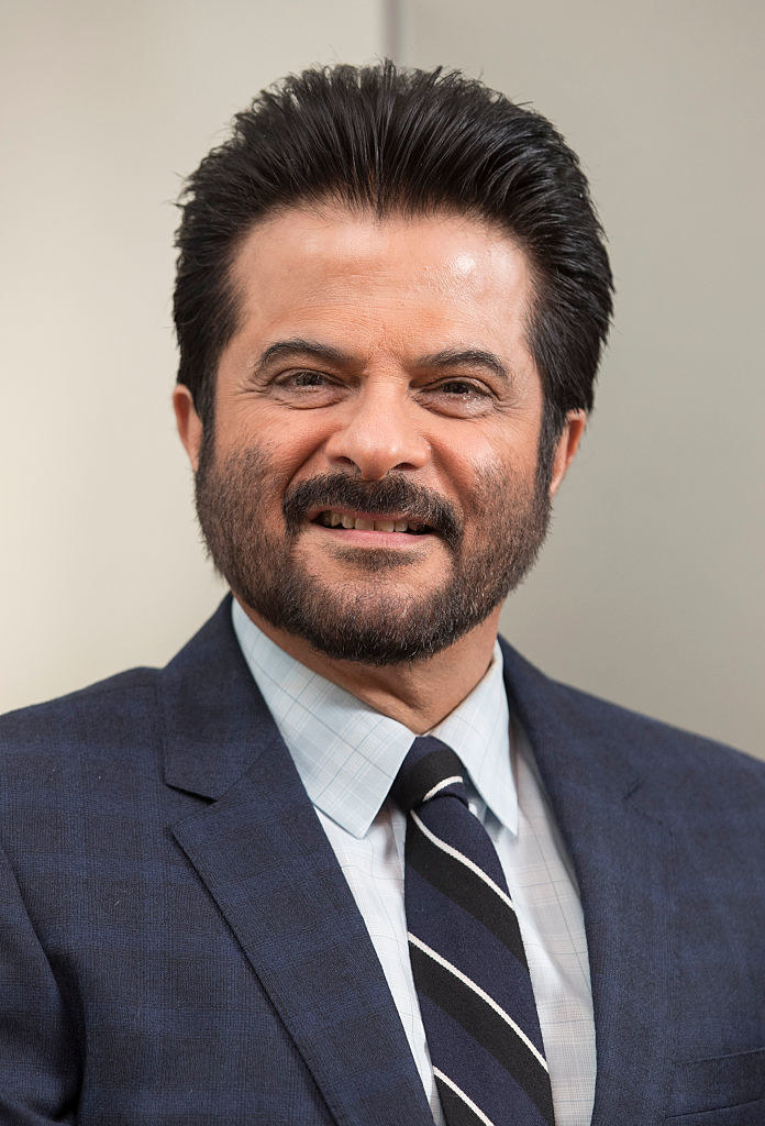 Anil Kapoor smiles and poses for photographers
