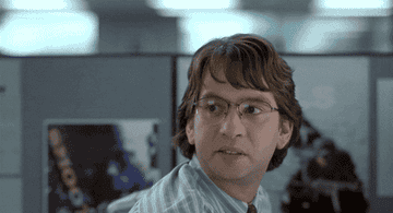 character from office space glaring over his shoulder at his desk
