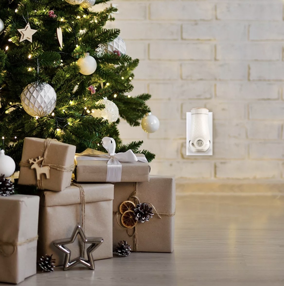 the air freshener plugged into outlet by Christmas tree