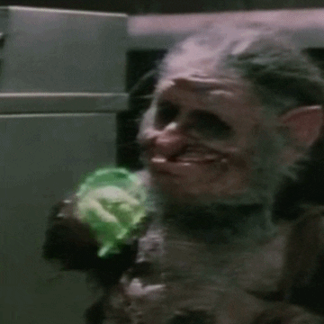 A GIF depicting a troll or goblin with grotesque features being engulfed in a neon green light before turning into a young girl