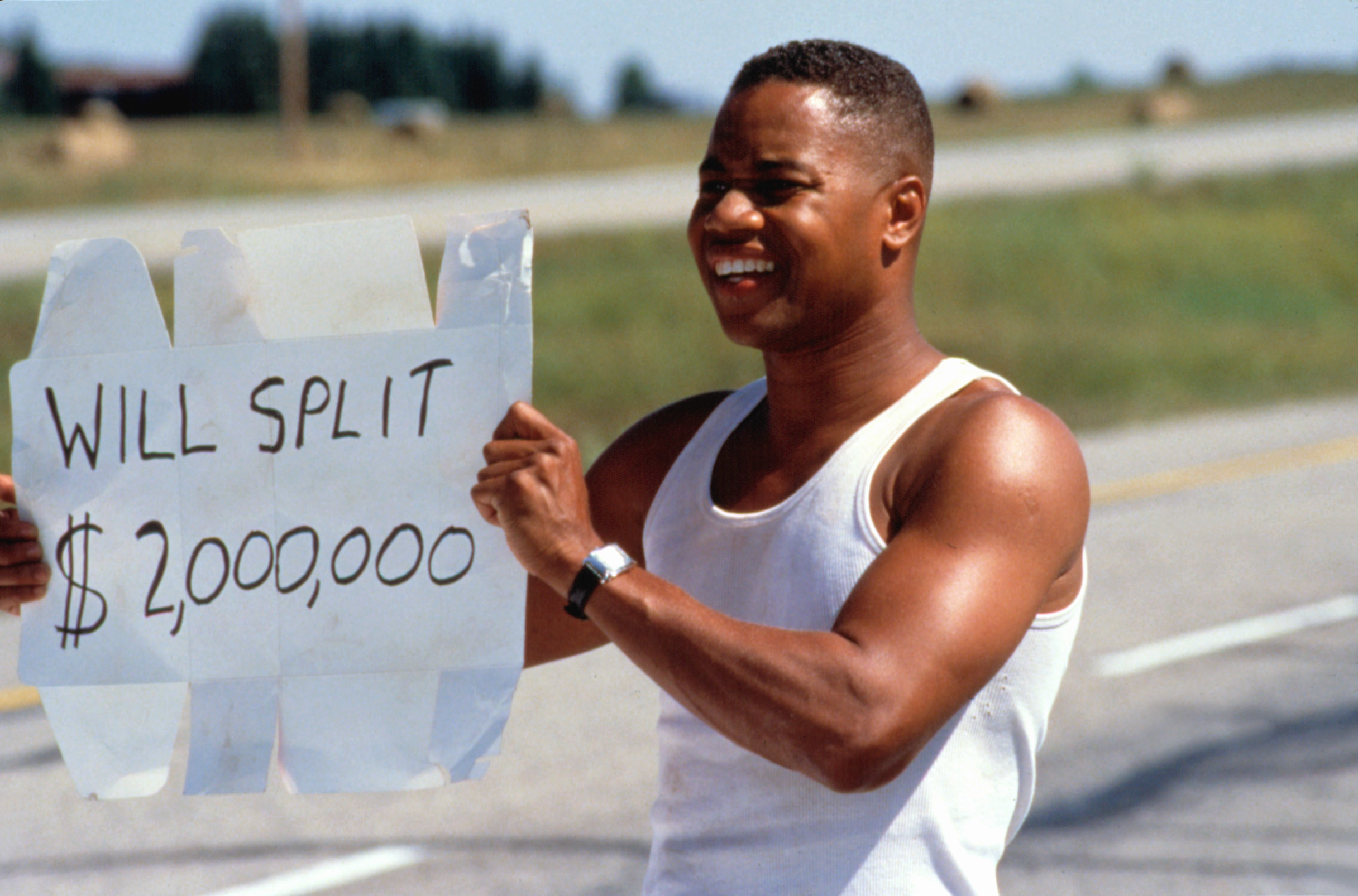 A man holding a sign reading: &quot;Will split $2,000,000&quot;
