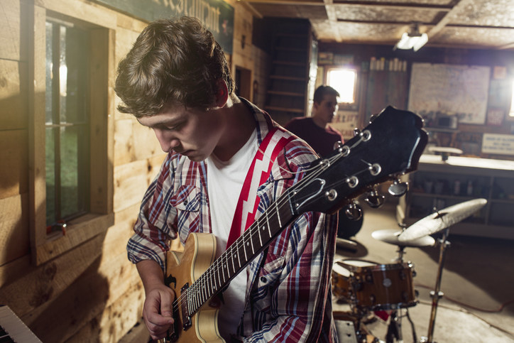 A young man playing guitar