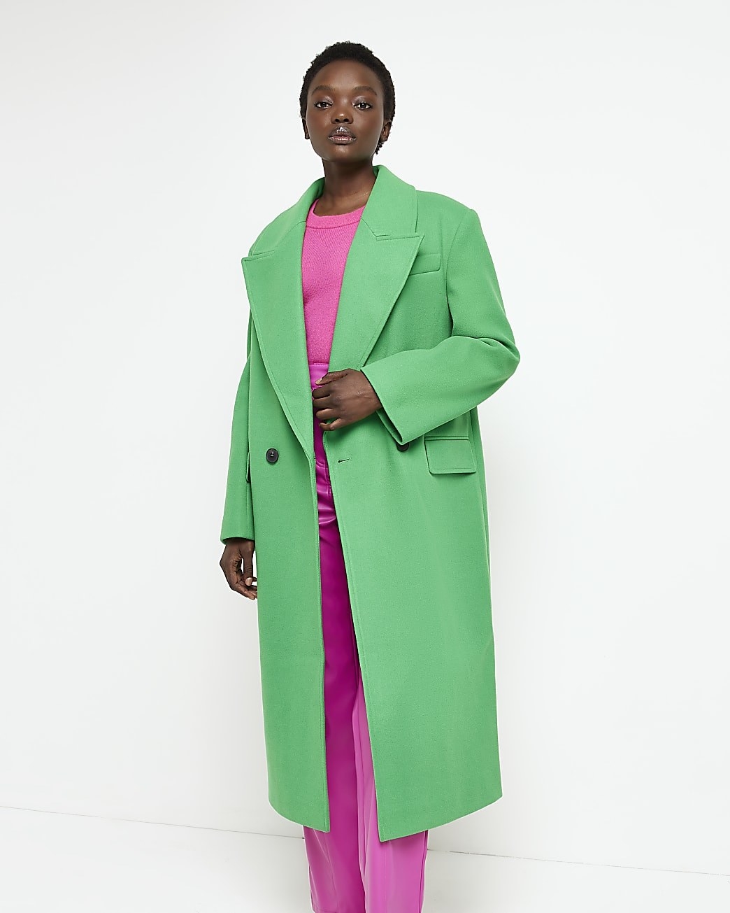 model in green overcoat with large lapels