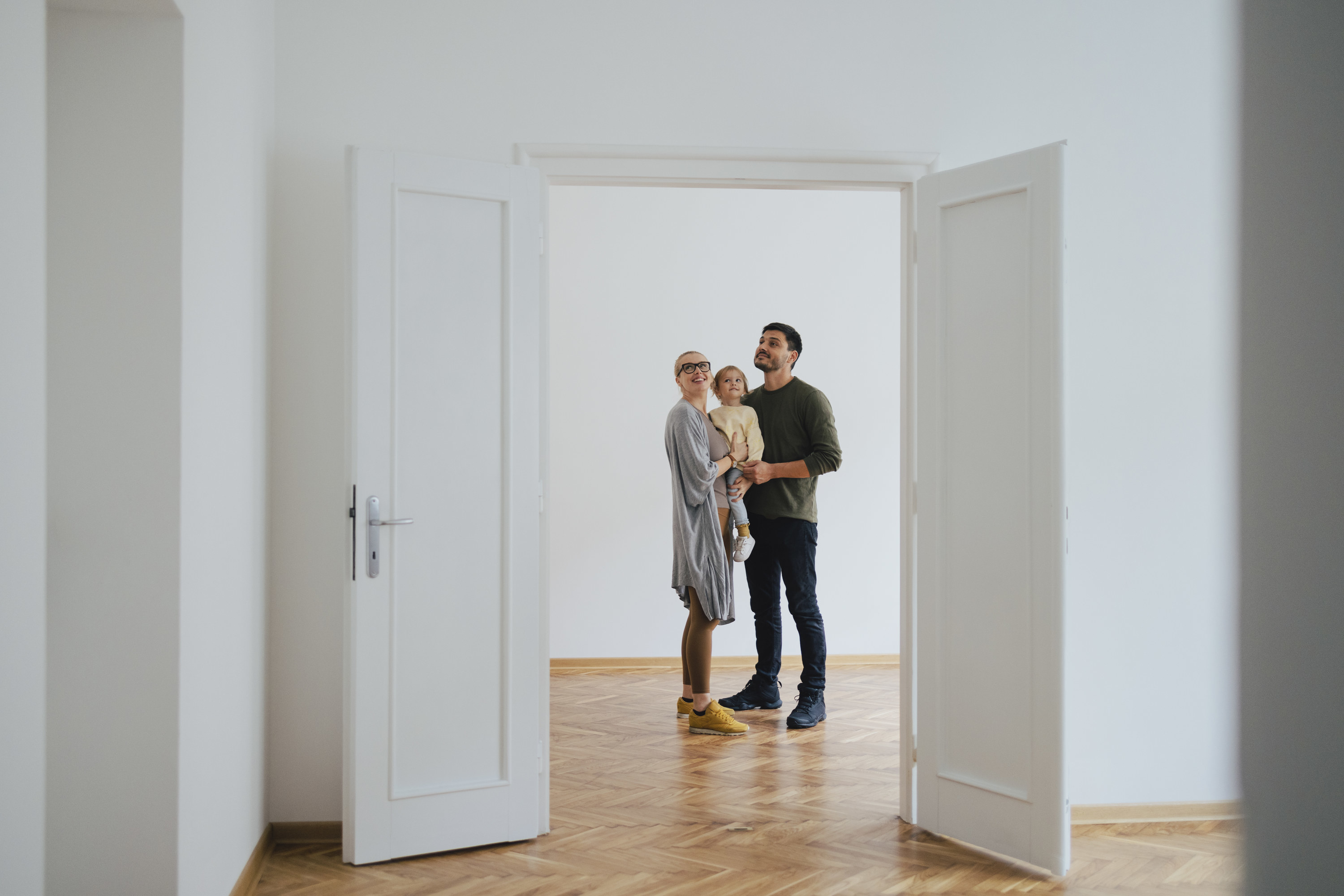 Family stands in an empty house