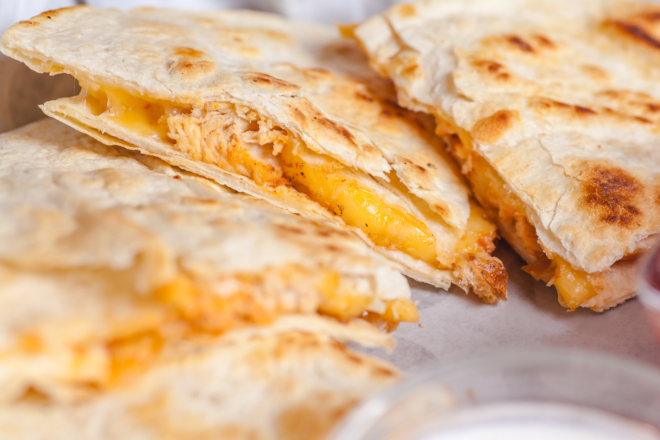 A cheese quesadilla cut into slices.