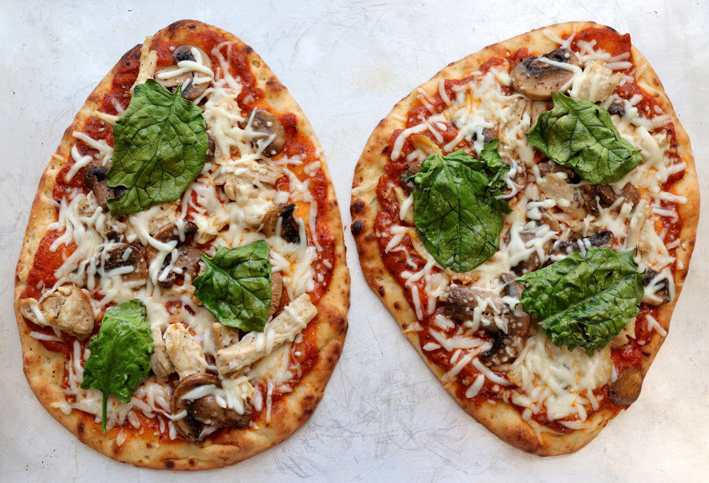 Naan flatbread with chicken and basil.