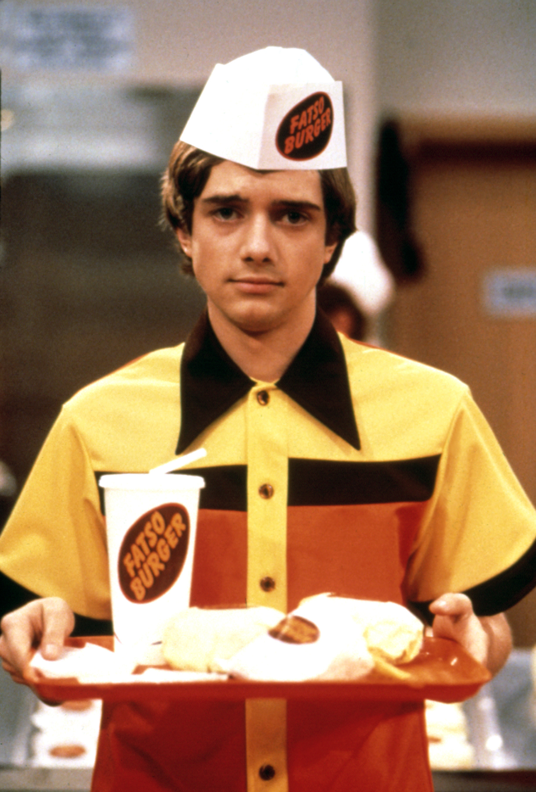 closeup of topher in a fast food uniform on the show