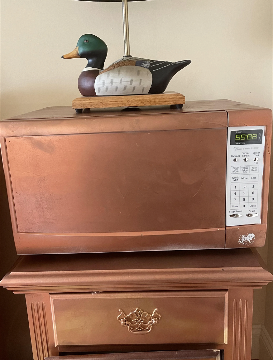 The microwave is painted copper to match the copper table