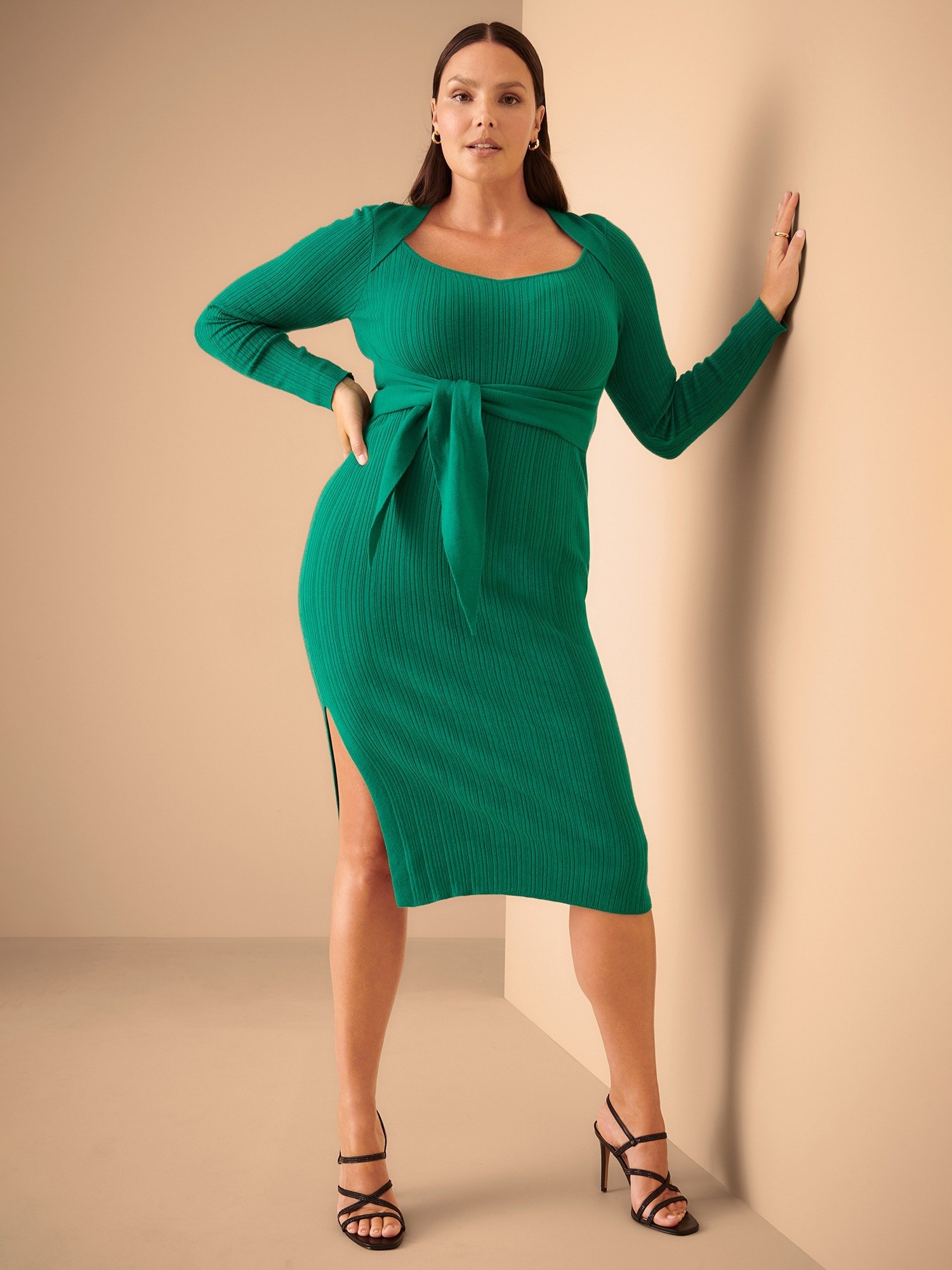 a model wearing the green dress