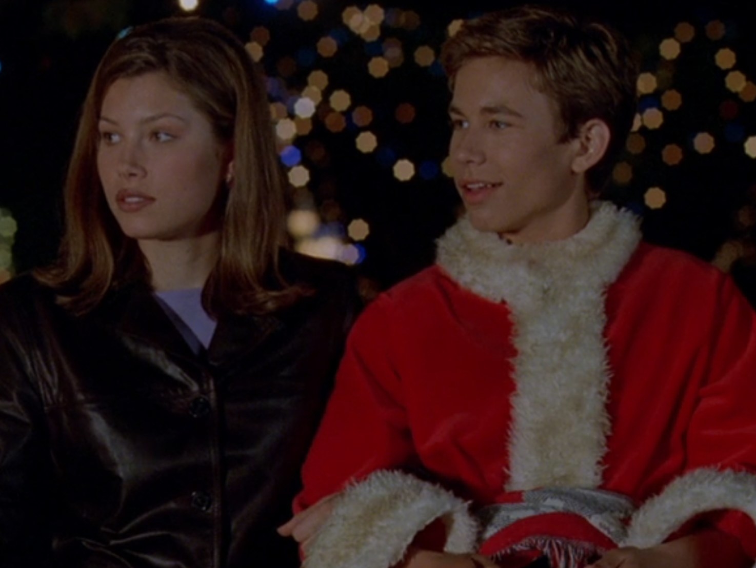Jessica Biel as Allie and Jonathan Taylor Thomas as Jake sit in a sleigh in &quot;I&#x27;ll Be Home for Christmas&quot;