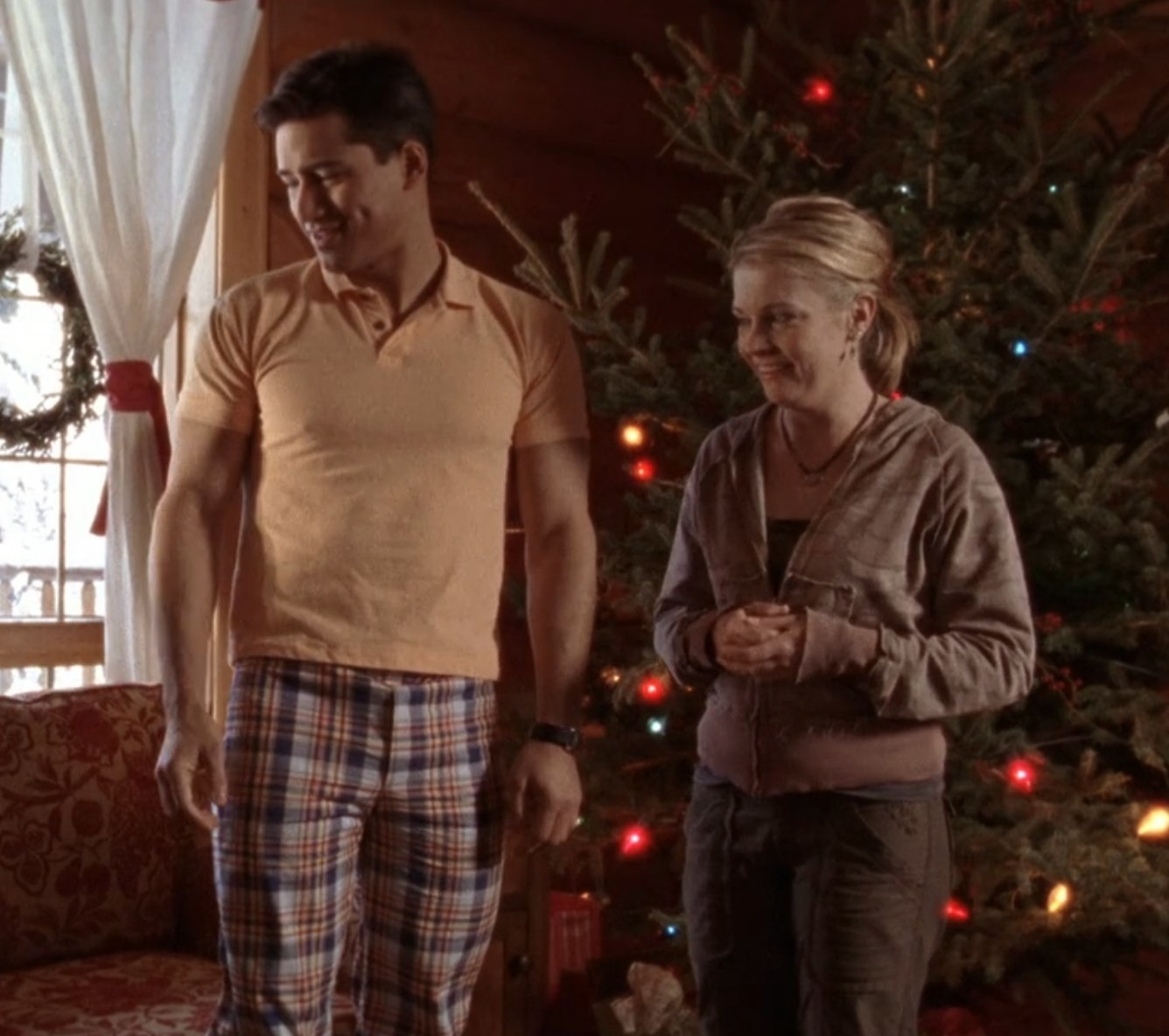 Mario Lopez and Melissa Joan Hart as Trudie and David talk to Trudie&#x27;s family members in &quot;Holiday in Handcuffs&quot;