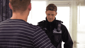 Scene from Hollyoaks where a character gets caught wearing pink fluffy slippers by a police officer