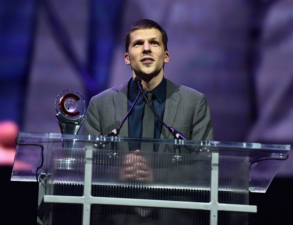 Jesse at a podium with an award