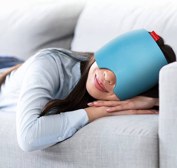 a person laying on the couch while wearing the slip-on head wrap