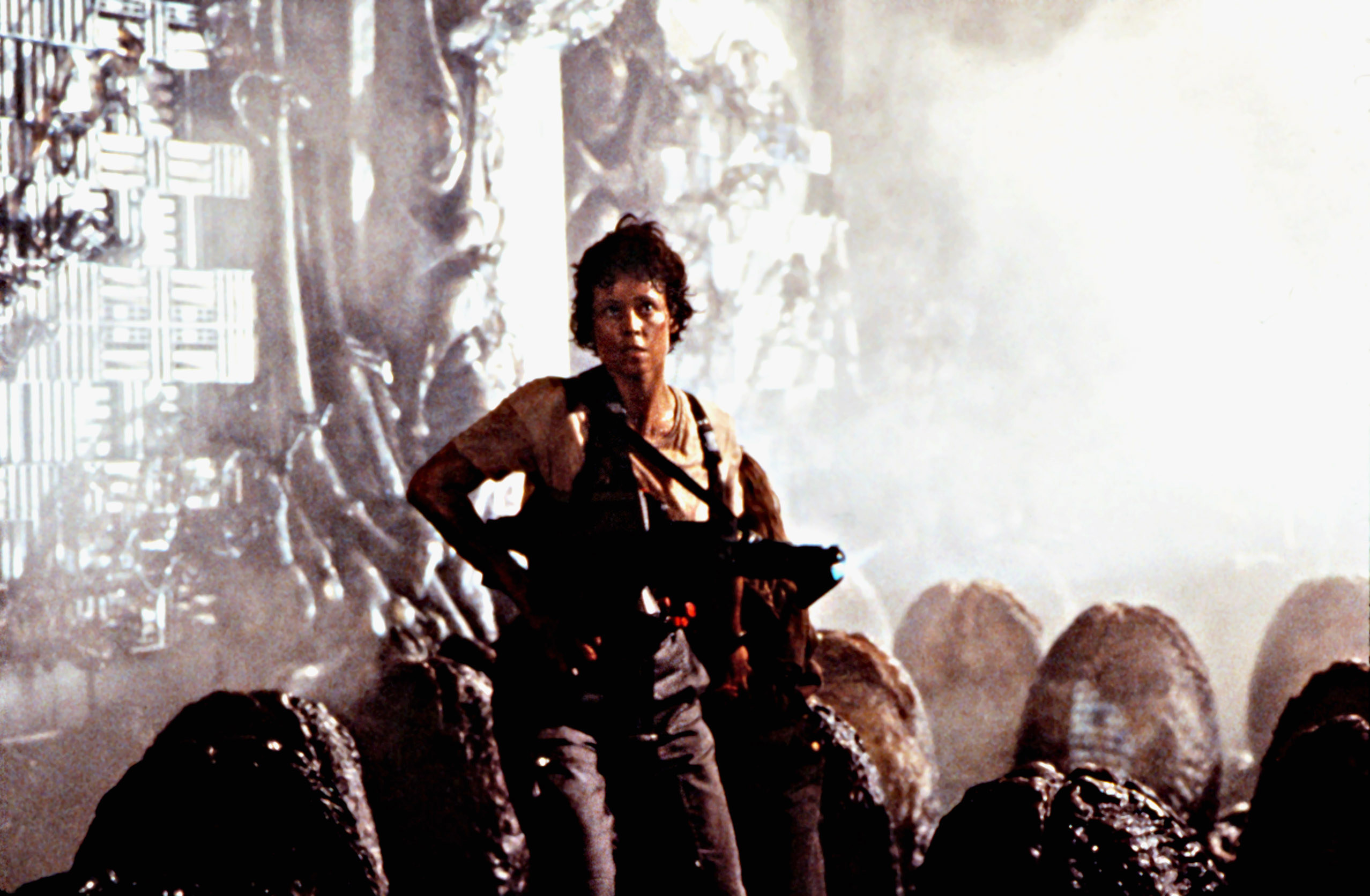 Sigourney Weaver running with a gun.