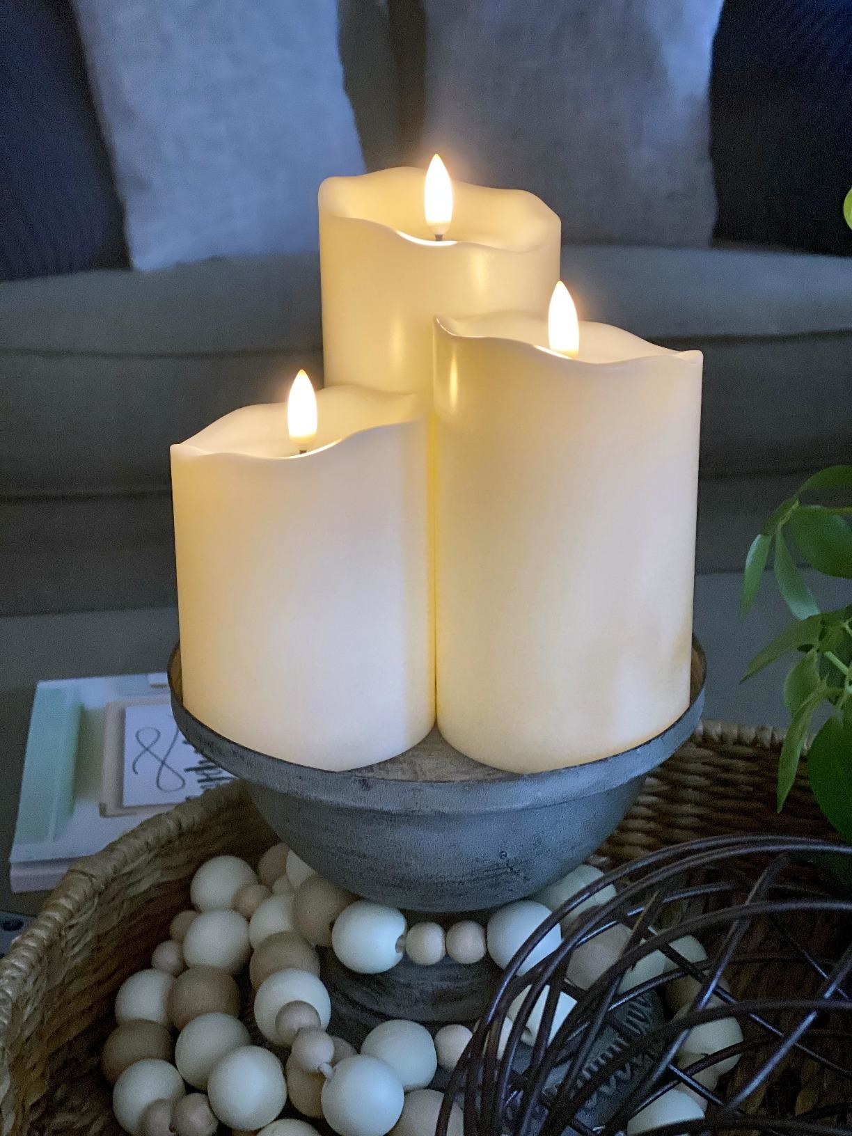 Reviewer image of three candles on a pedestal