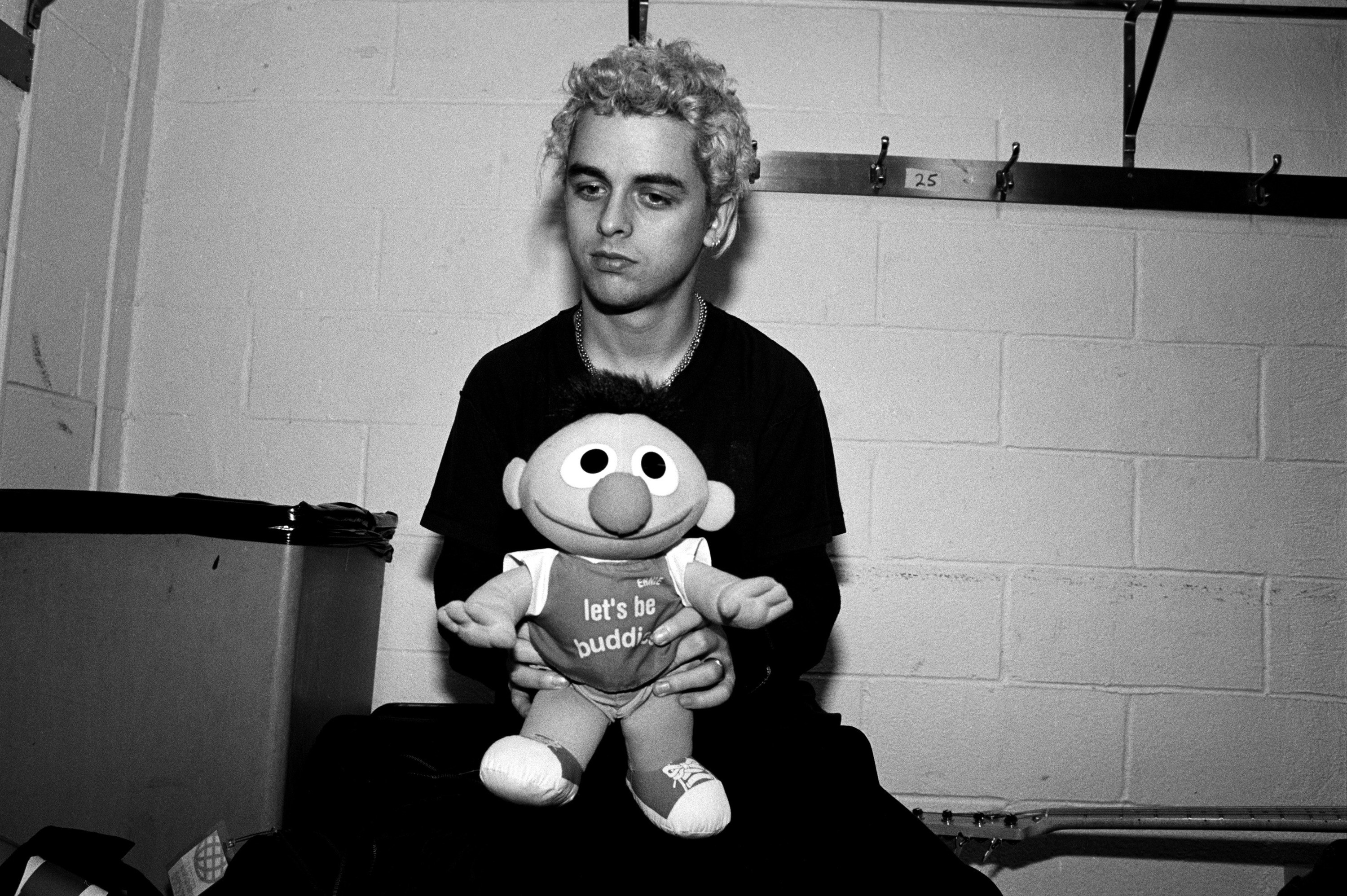 green day band member holding an ernie doll