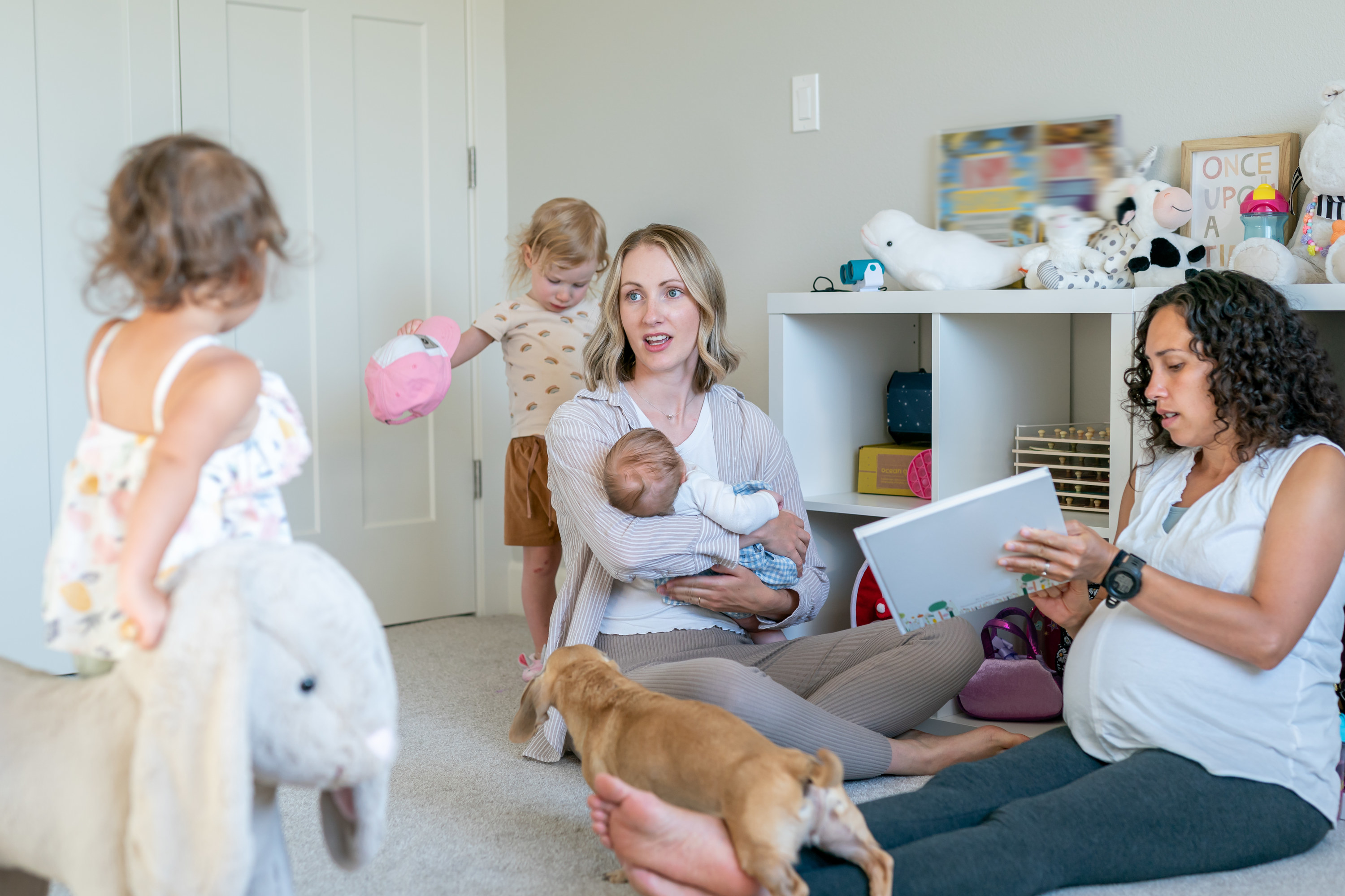 Kids socializing while a pregnant and postpartum mom talk