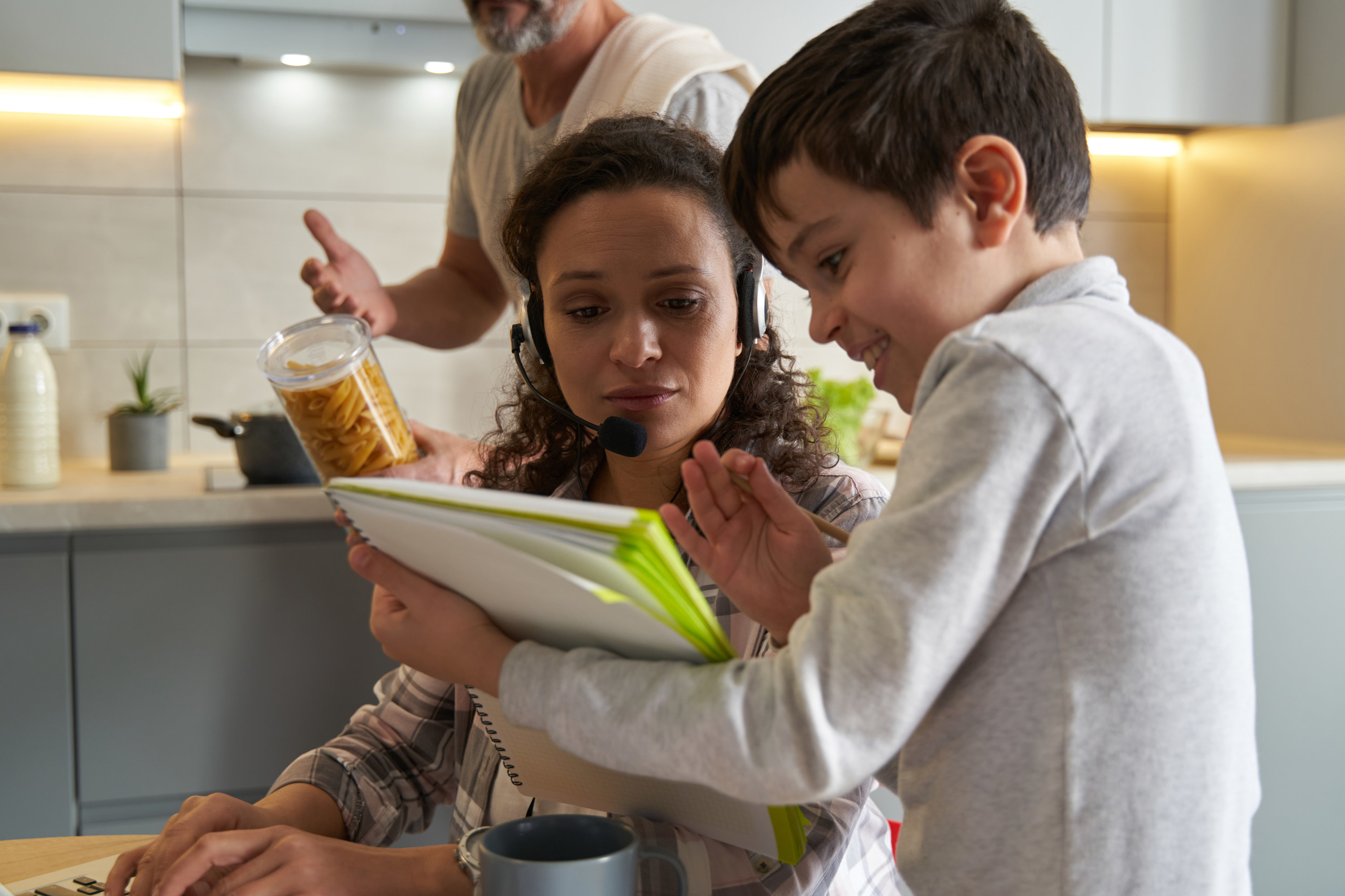 mom working while husband and son try talking to her